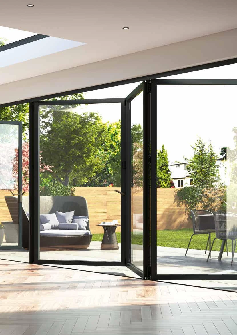 Black-framed Korniche aluminium bi-fold doors opening onto a garden