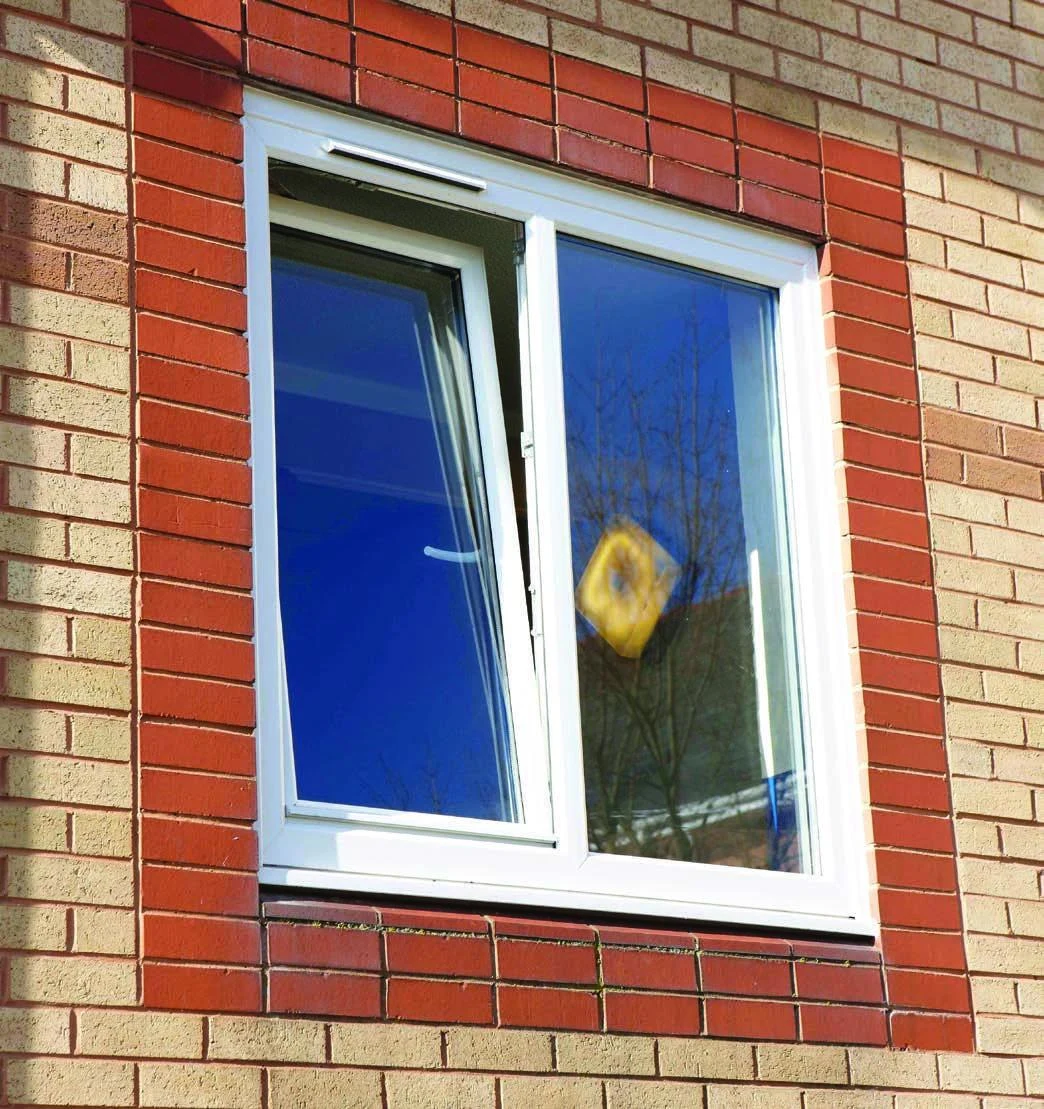 White tilt-and-turn window with one sash tilted inward